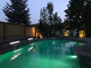 Backyard with pool at night