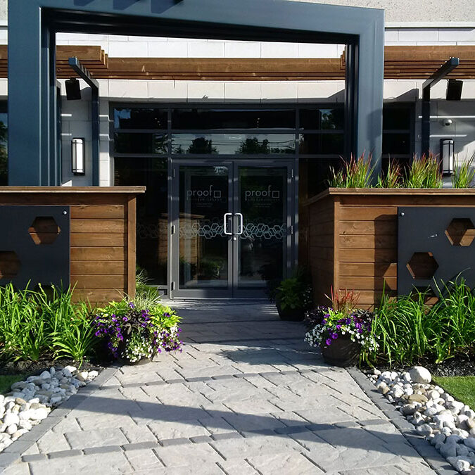 Front entrance of a building with plants and landscape